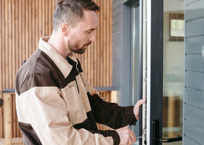 young-repairman-fixing-lock-in-large-transparent-door.jpg